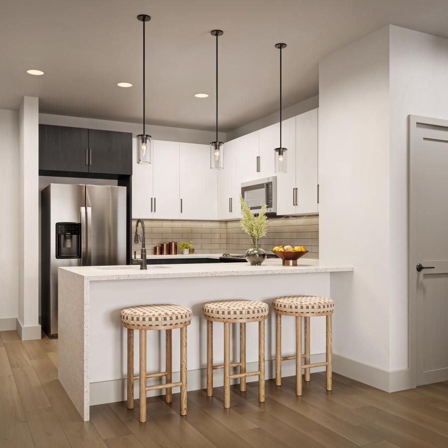 a kitchen with a bar stool and a table
